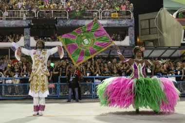 Rio, Brazil - February 23, 2020: parade of the samba school Mangueira, at the Marques de Sapucai Sambodromo. 1st Master of Ceremonies and Flag Bearer Couple Matheus Oliverio and Squel Jorge