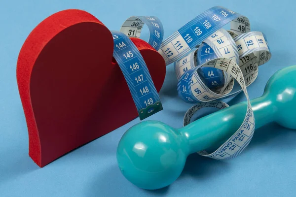heart problems related to metabolic syndrome symbolized by the shape of the heart with a measuring tape