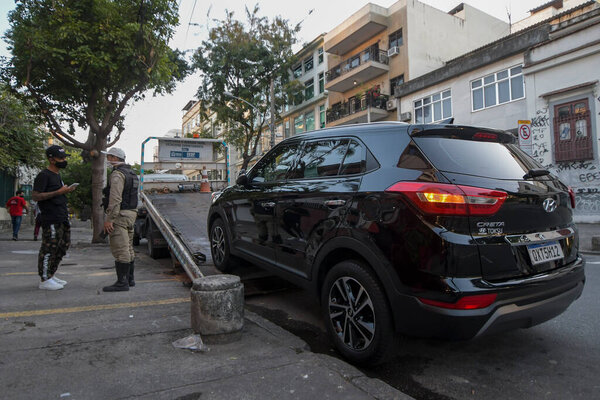 Rio, Brazil - july 10, 2021: car being towed for on-day parking prohibited on city street