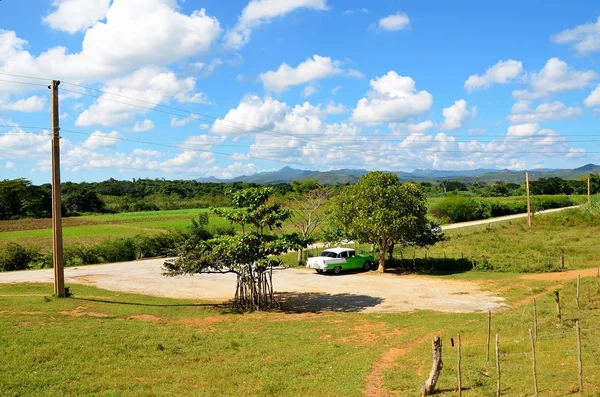 Alte amerikanische autos in iznaga - valle de los ingenios, kuba — Stockfoto