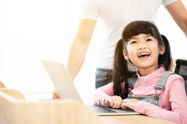 Asian girl student online learning class study using laptop and parent take care. Concept of online education and homeschool