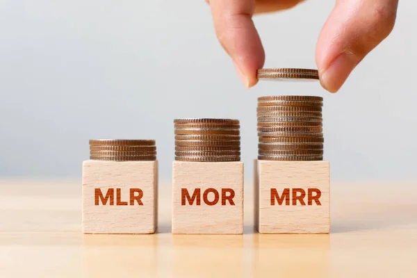Interest rate mortgage property investment MLR, MOR, MRR. Coin stack step on wooden block