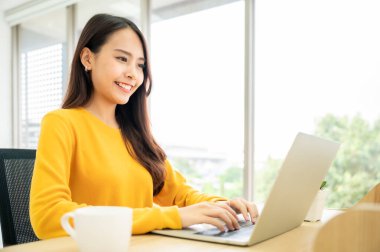 Evde çalışmak, video konferansı, çevrimiçi görüşme videosu bilgisayar ekranına bakan güzel Asyalı kadın Webinar izlemek ve evde dizüstü bilgisayarla çalışmak.