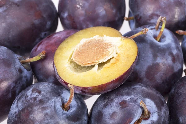 Fruits of plum, whole and cut, close up — Stock Photo, Image