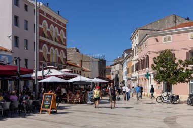 Porec, Hırvatistan, Istria - 25 Eylül 2023: Eski Kentin en büyük ve en popüler meydanı olan Özgürlük Meydanı 'ndaki İnsanlar (Trg Slobode)