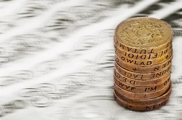 Sterling pound depreciation devaluation reduction value concept closeup macro view at UK currency stack of one pound coins — Stock Photo, Image