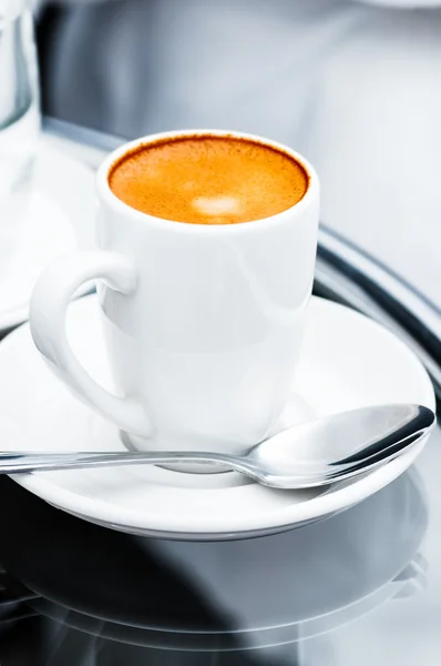 Espresso coffee full cup and saucer on bedside table closeup — Stock Photo, Image