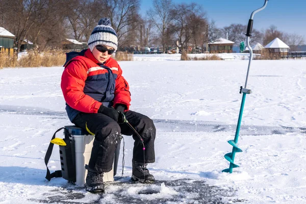 湖の氷で冬の釣りを楽しむ少年8 — ストック写真