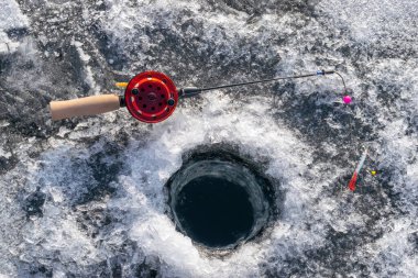 Winter fishing rod by the hole in the ice 4 clipart