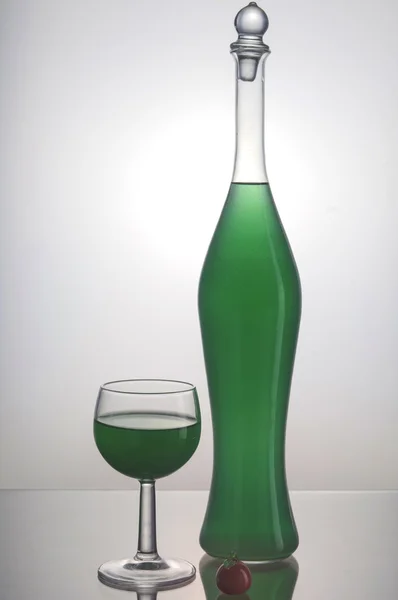 Transparent bottle with green liquid — Stock Photo, Image