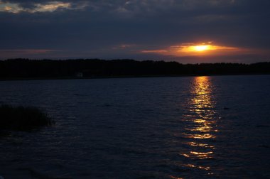 Zaman atlamalı olarak büyük güneş batmadan okyanus üzerinde ufuk içine büyük turuncu günbatımı