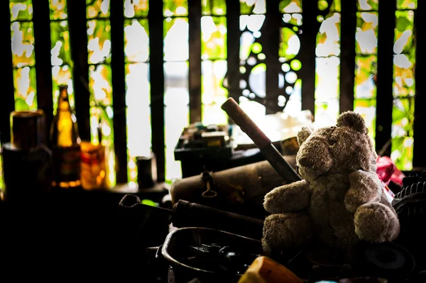 Bear doll with Old tool in dirty place — Stock Photo, Image