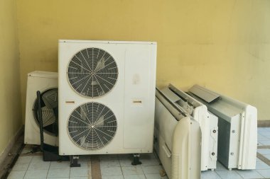 Atılmış havalandırma üniteleri bir odada depolanmış. Bu üniteler tamir ya da imha edilmesi gereken modası geçmiş teknolojiyi temsil ediyor. İklim ve enerji tartışmaları için ideal.