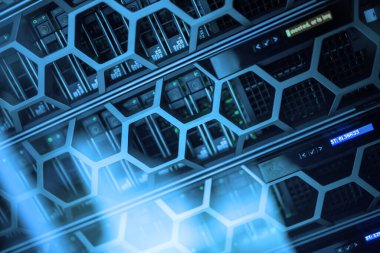 Karmaşık altıgen tasarımlar ve mavi ışıklandırma içeren, gelişmiş veri depolama ve ağ teknolojisini eylem halinde gösteren modern bir sunucu rafının yakın görüntüsü.