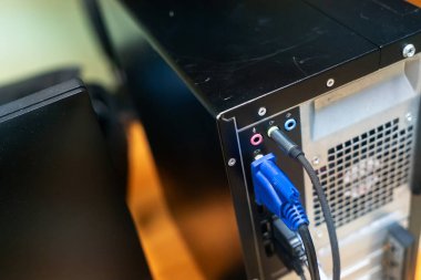 A close-up view of a computer's back panel showcasing various ports and connectors. This image captures the essential hardware components for connectivity.