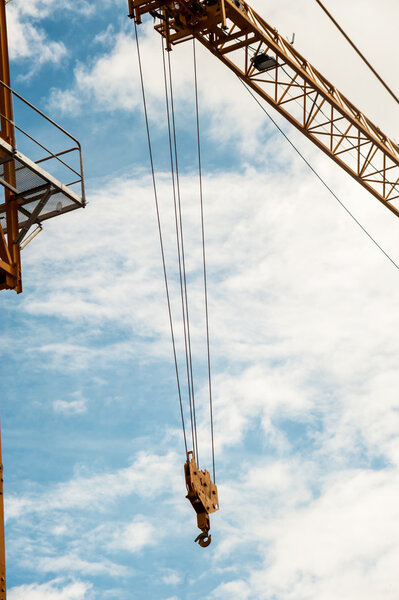An Crane in construction with blue sky .