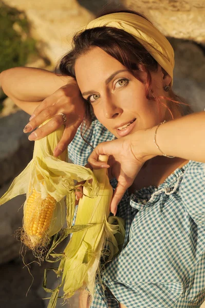 Portrait of stylish pretty woman with corn.