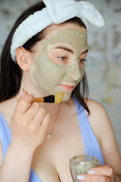 Mooie Jonge Vrouw Smeert Haar Gezicht Met Cosmetische Klei Een — Stockfoto