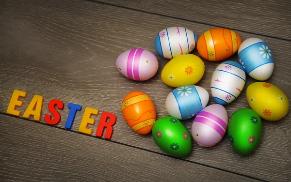 Easter eggs and decoration on wooden background — Stock Photo, Image