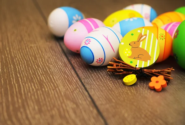 Easter eggs and decoration on wooden background — Stock Photo, Image