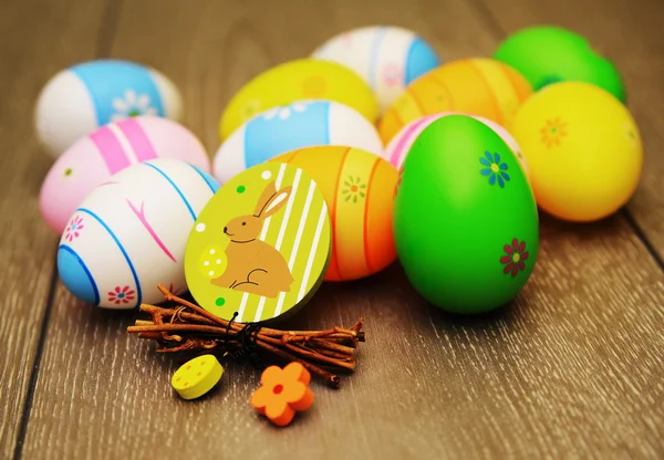 Easter eggs and decoration on wooden background — Stock Photo, Image