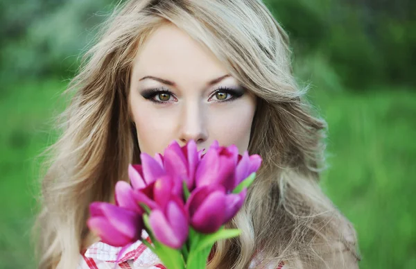 Portrait of young woman with a flowers Royalty Free Stock Photos