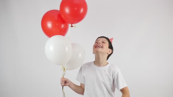 Urodziny Balony Radosny Chłopiec Czerwonym Kapeluszu Urodzinowym Czerwone Białe Kulki — Wideo stockowe