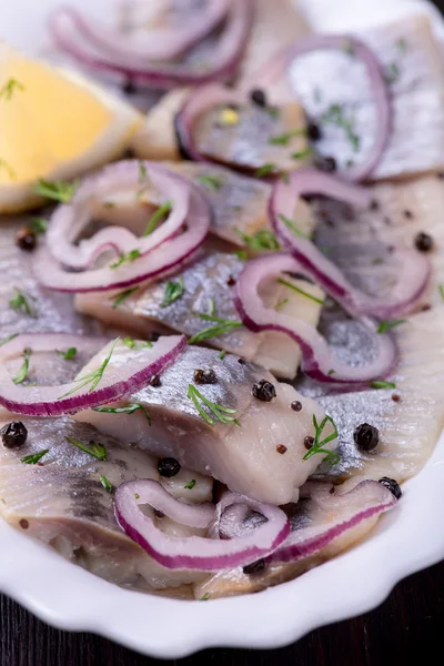 Sliced herring with pepper, herbs, salt, onion — Stock Photo, Image