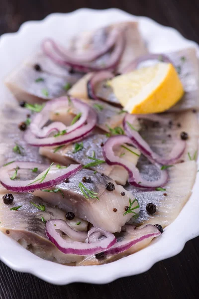 Sliced herring with pepper, herbs, salt, onion — Stock Photo, Image