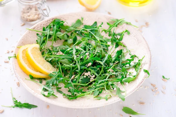 Fresh arugula salad with seeds — Stock Photo, Image