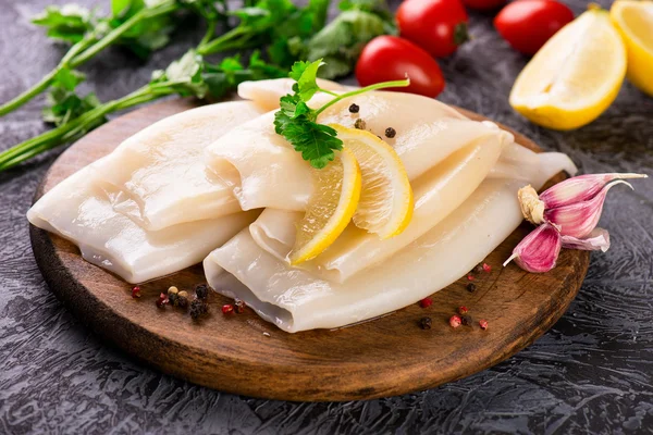 Preparation of raw squid and ingredients on board Stock Image