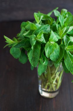 Tahta arka planda taze nane yaprakları