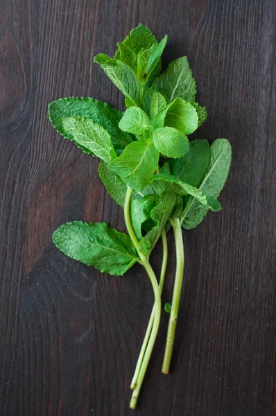 Fresh mint leaves on the wooden background — Stock Photo, Image