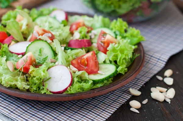 Tomato and cucumber salad with lettuce leafes — Stock Photo, Image