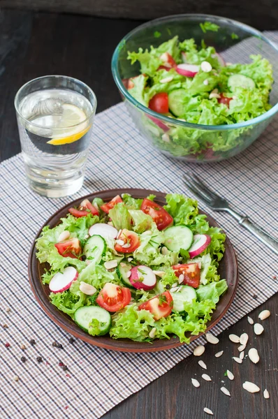 Tomato and cucumber salad with lettuce leafes — Stock Photo, Image