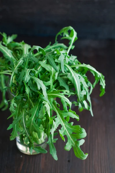 Fresh ruccola leaves on the wooden background — Stock Photo, Image