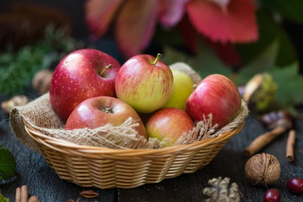 Pommes fraîches avec feuilles d'automne sur table en bois — Photo