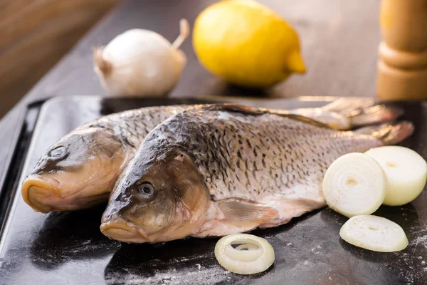 Fresh carp fish with spices and lemon — Stock Photo, Image