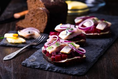 Sandviç ile ringa balığı ve pancar kayrak bir plaka üzerinde