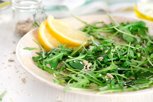 Fresh arugula salad with seeds — Stock Photo, Image