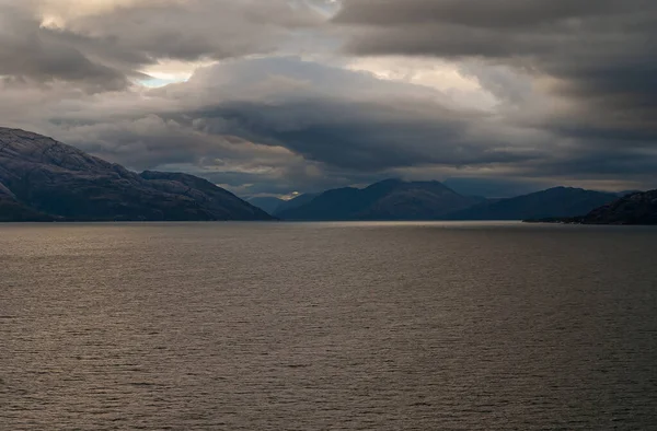 Sarmiento Channel 2008年12月11日 Amalia Glacier Fjord 入り口の山の上に複数の層の雲の風景 薄いパッチと暗い灰色の海の水 — ストック写真