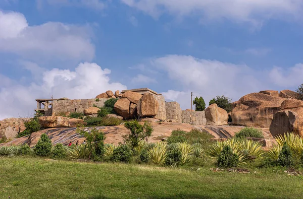 stock image Krishnapura, Karnataka, India - November 4, 2013: the Hemakatu hillock where small temple and Sasivekaly Ganesha or Mustard Seed resides under blue cloudscape. Brown boulders and green weed.