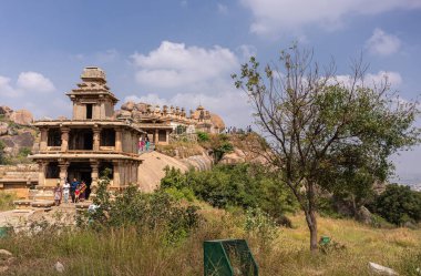 Chitradurga, Karnataka, Hindistan - 10 Kasım 2013: Fort veya Elusuttina Kote. Yeşil yapraklı mavi bulutların altındaki Hidambeswara Tapınağı 'nın uzun manzarası. Giysiler renk ekler