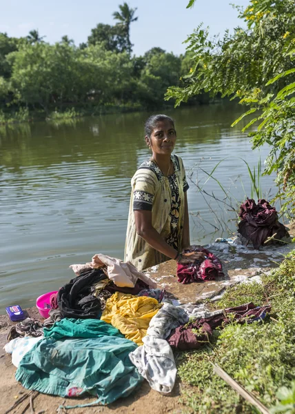 Frau wäscht im Fluss stehende Wäsche. — Stockfoto