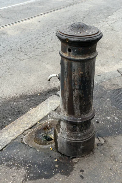 A drinking fountain on one of the streets of Rome in Italy. Classic Roman fountain with drinking water.