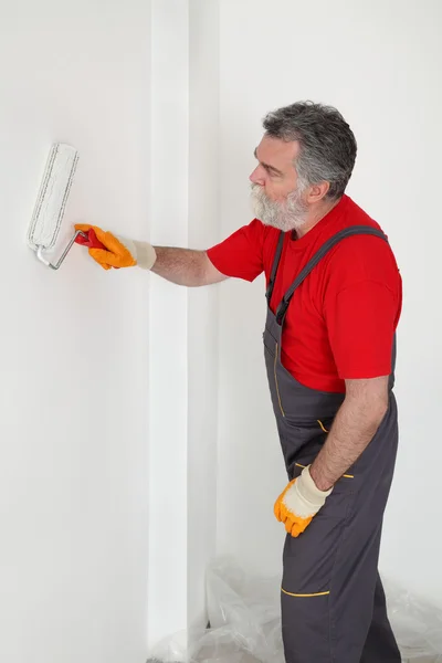 Werknemer schilderen muur in de kamer — Stockfoto