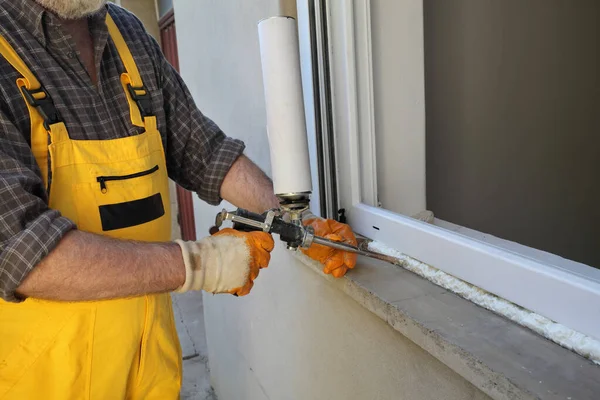 Worker Installing New Plastic Window Using Handgun Polyurethane Foam — Stock Photo, Image
