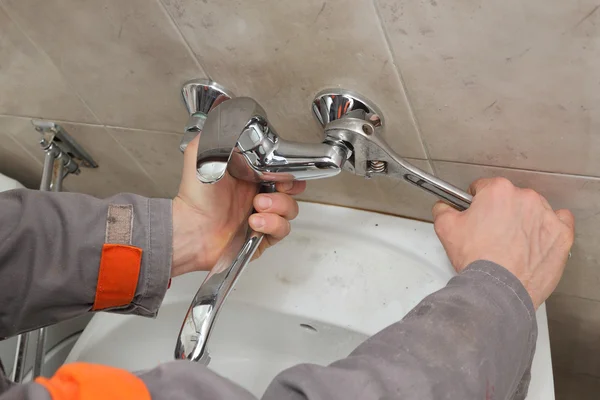 Grifo de fijación de fontanero en un baño — Foto de Stock