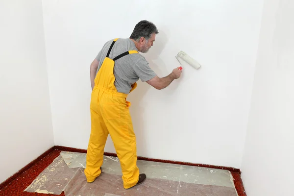 Munkavállaló festés fal a szobában — Stock Fotó