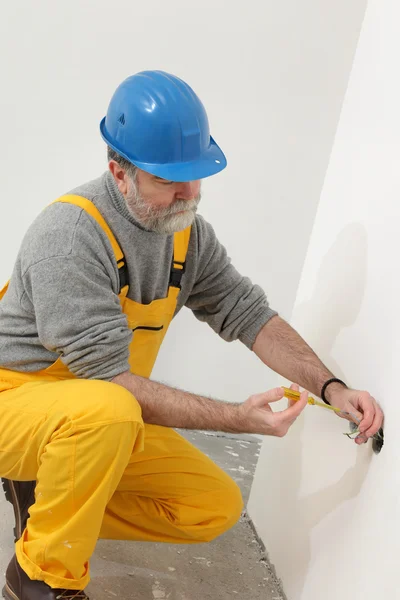 Electrician at construction site testing installation — Stock Photo, Image